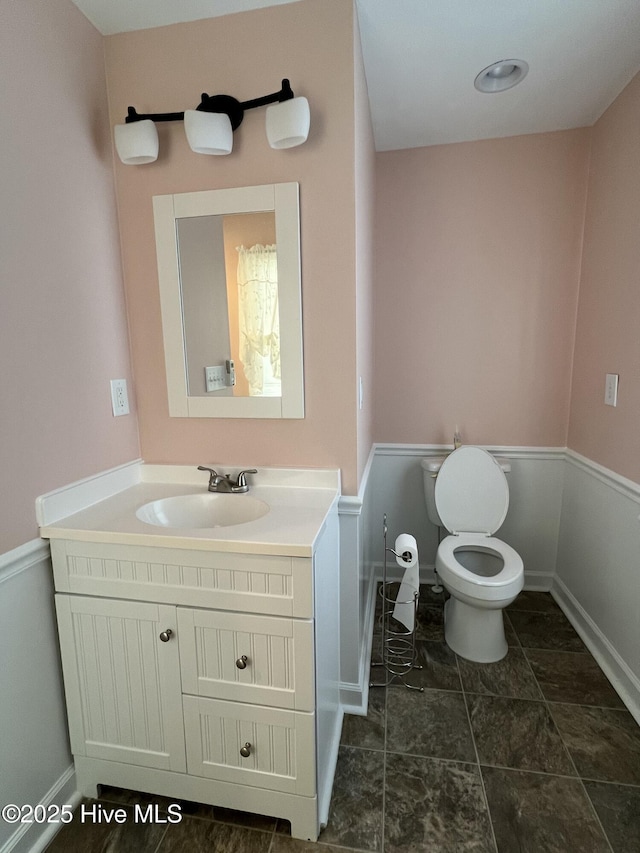 bathroom with vanity and toilet