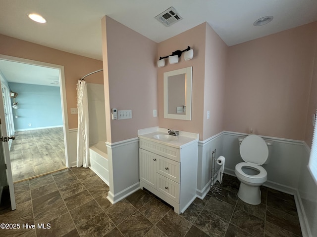 full bathroom with shower / bath combo with shower curtain, vanity, and toilet