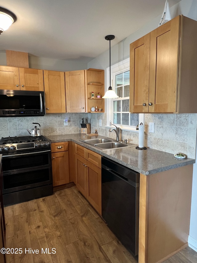 kitchen featuring dishwasher, sink, dark hardwood / wood-style floors, double oven range, and decorative light fixtures