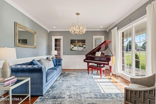 living room with an inviting chandelier, wood-type flooring, and crown molding