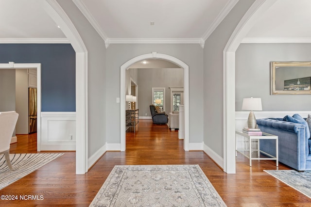 foyer entrance with crown molding and hardwood / wood-style flooring