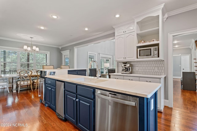 kitchen featuring blue cabinets, sink, appliances with stainless steel finishes, a kitchen island with sink, and white cabinets