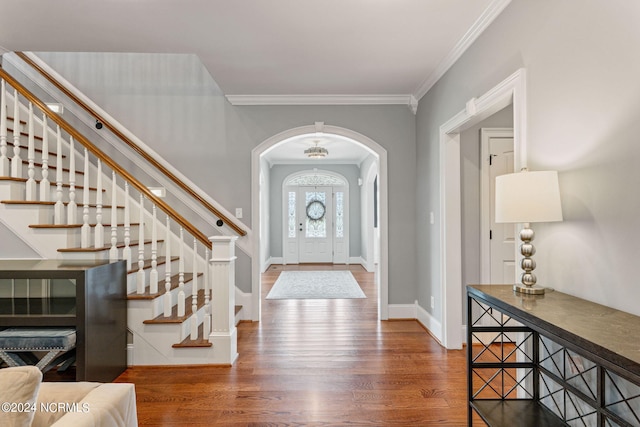 foyer featuring dark wood-type flooring and crown molding