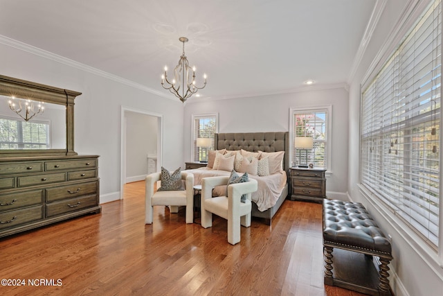 bedroom with an inviting chandelier, crown molding, and light hardwood / wood-style flooring