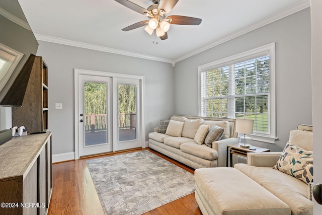 living room featuring crown molding, ceiling fan, and hardwood / wood-style floors