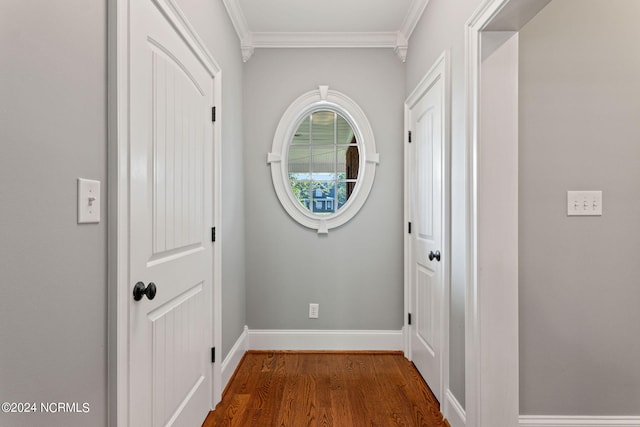 entryway featuring ornamental molding and dark hardwood / wood-style flooring