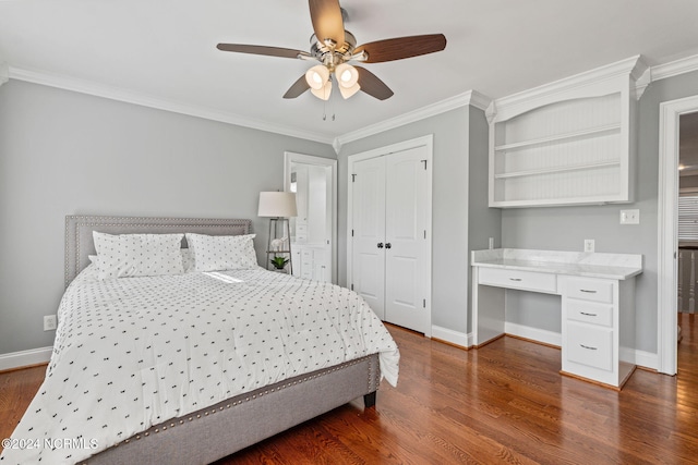 bedroom with built in desk, ornamental molding, dark hardwood / wood-style flooring, a closet, and ceiling fan