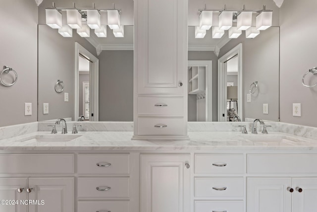 bathroom featuring crown molding and vanity