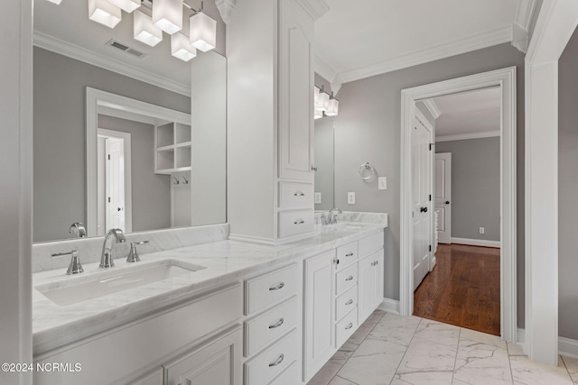 bathroom featuring crown molding and vanity