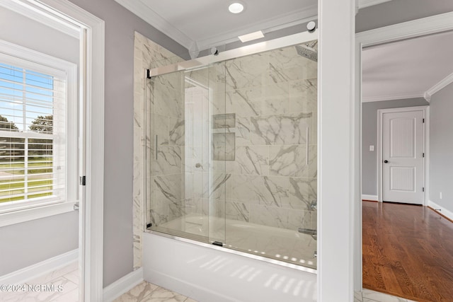 bathroom featuring crown molding and shower / bath combination with glass door