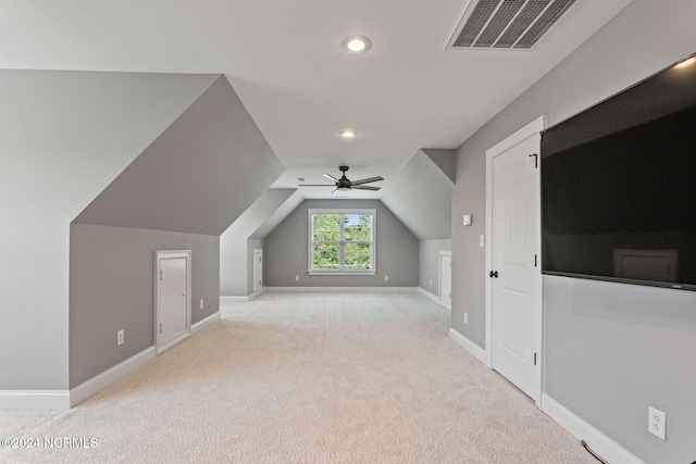 bonus room with ceiling fan, lofted ceiling, and light carpet