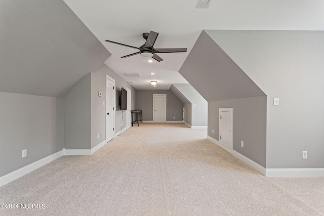 additional living space with ceiling fan, lofted ceiling, and light carpet