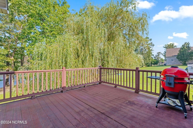 wooden deck featuring a yard