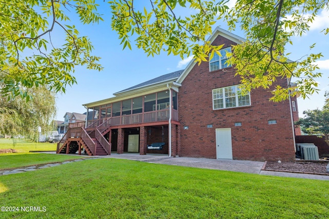 view of side of property with a sunroom, a yard, and a patio area