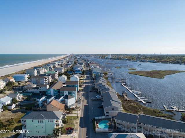 bird's eye view with a water view and a beach view