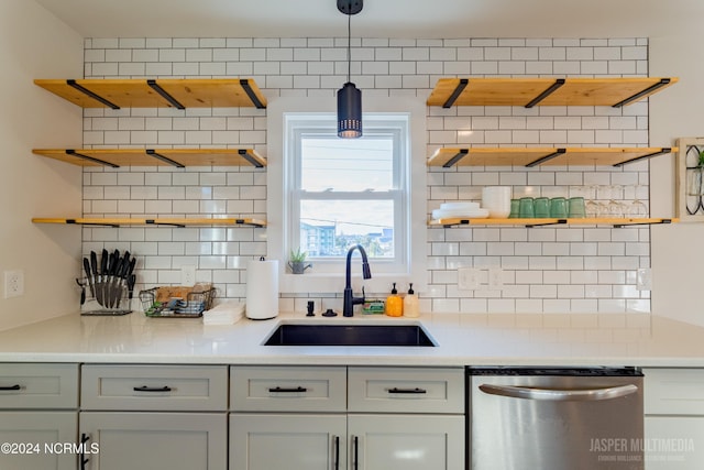 kitchen with tasteful backsplash, decorative light fixtures, and stainless steel dishwasher