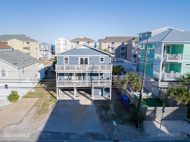 back of house with a balcony and a garage