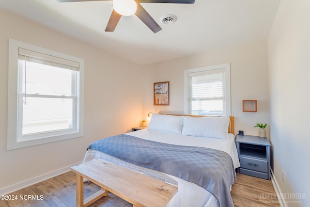 bedroom with light hardwood / wood-style flooring and ceiling fan