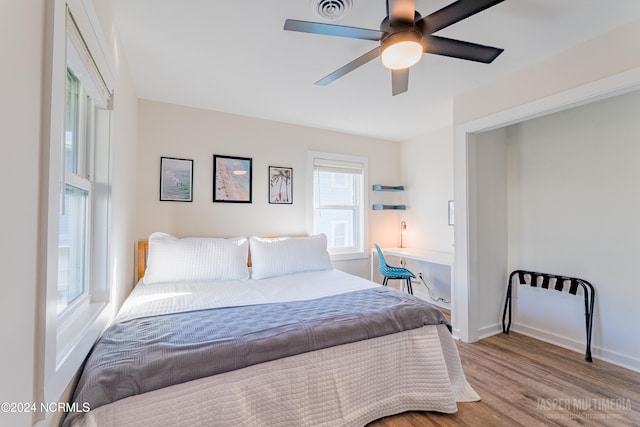 bedroom with ceiling fan and light wood-type flooring