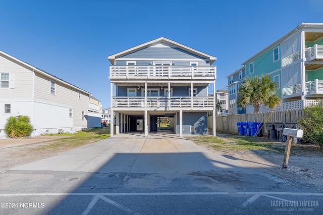 view of front facade featuring a carport and a balcony