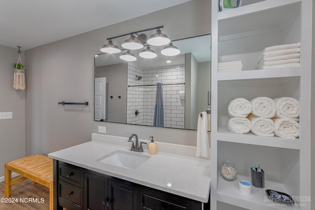 bathroom featuring vanity and a tile shower