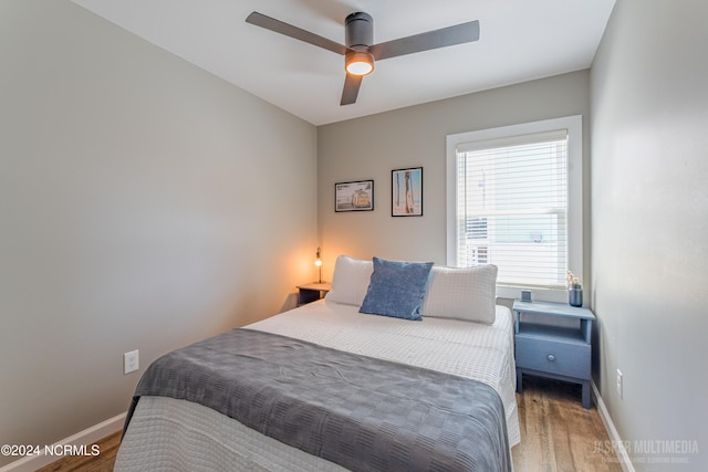 bedroom with wood-type flooring and ceiling fan