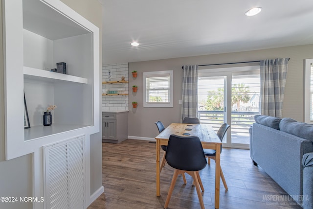 dining room with a wealth of natural light and dark hardwood / wood-style flooring