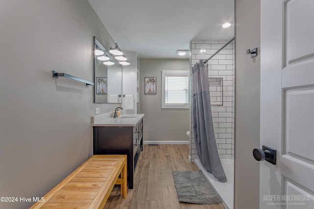 bathroom with vanity, curtained shower, and wood-type flooring