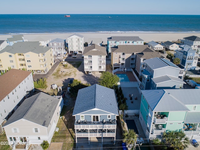 drone / aerial view with a water view and a beach view