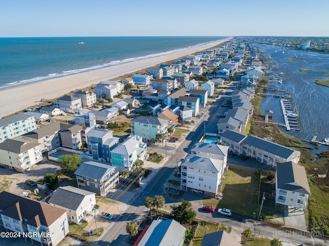 drone / aerial view featuring a water view and a beach view