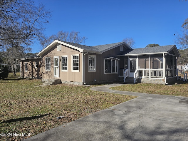 ranch-style home with a sunroom and a front yard