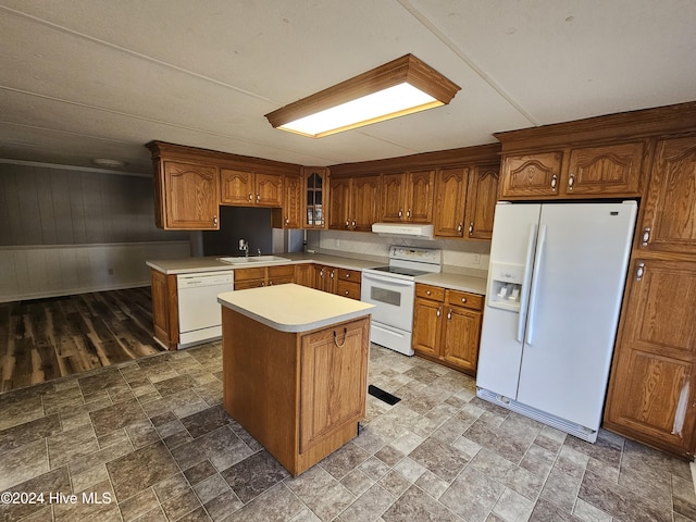 kitchen featuring white appliances, a center island, and sink