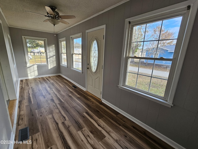 entrance foyer with ceiling fan, ornamental molding, dark hardwood / wood-style flooring, and a textured ceiling