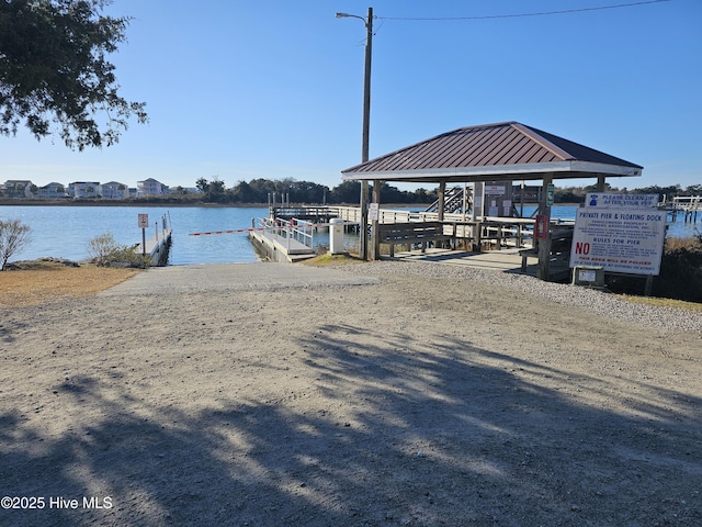 view of dock featuring a gazebo and a water view