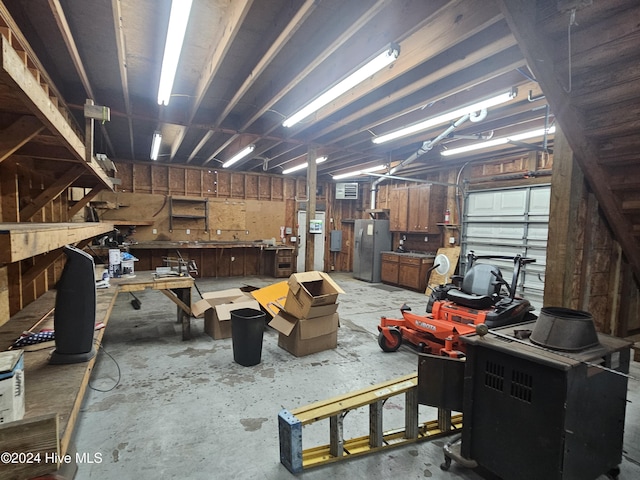 miscellaneous room featuring a workshop area and concrete floors