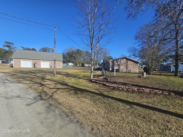 view of yard with a garage and an outdoor structure