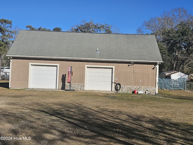 garage featuring a lawn