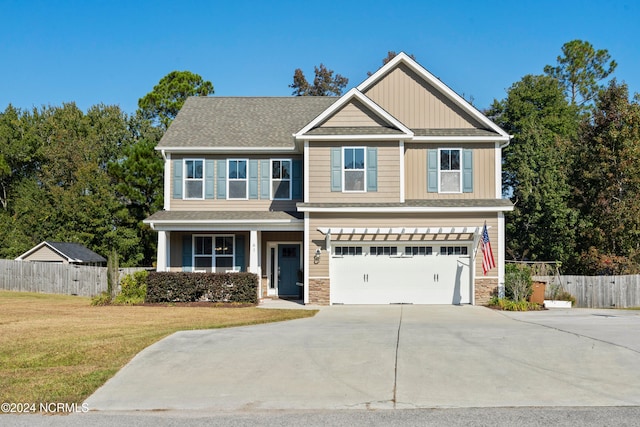 craftsman-style house featuring a front lawn and a garage