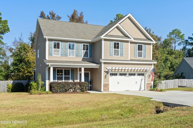 craftsman inspired home featuring a front yard and a garage