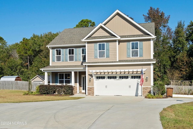 craftsman-style home with a front yard and a garage