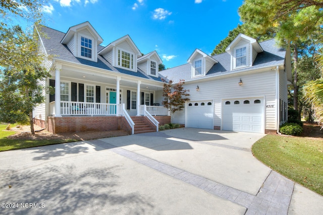 4315 Loblolly Cir SE, Southport, NC 28461 - new england style home with covered porch, driveway, an attached garage, and roof with shingles