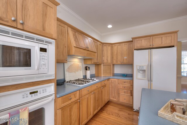 4315 Loblolly Cir SE, Southport, NC 28461 - kitchen with white appliances, light wood-style flooring, ornamental molding, recessed lighting, and custom range hood