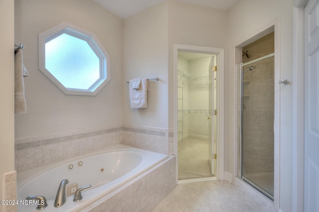 4315 Loblolly Cir SE, Southport, NC 28461 - full bathroom featuring a stall shower, a spacious closet, tile patterned flooring, and a whirlpool tub