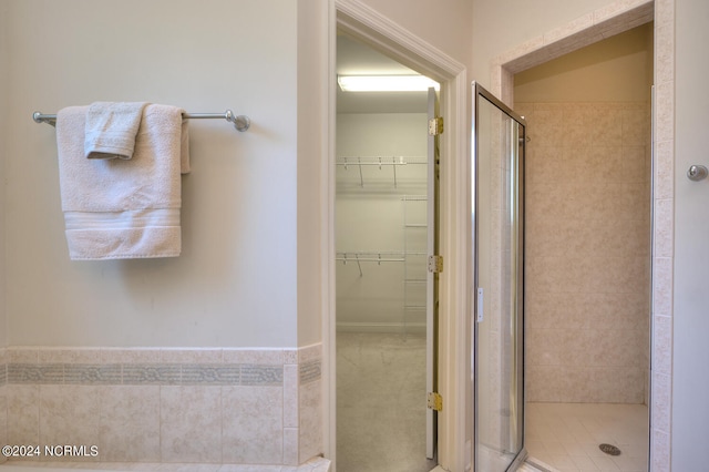 bathroom featuring a shower with door