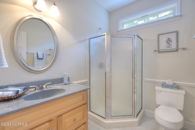 bathroom with vanity, tile patterned flooring, toilet, and an enclosed shower