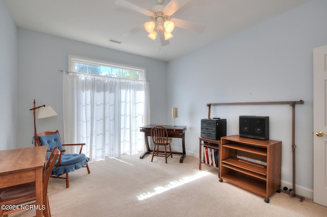 living area featuring carpet flooring and ceiling fan