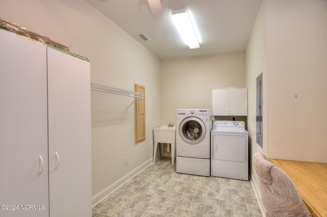 laundry area featuring light hardwood / wood-style floors, cabinets, washer and clothes dryer, and ceiling fan