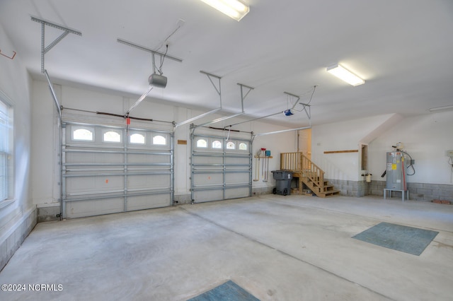 garage featuring water heater and a garage door opener