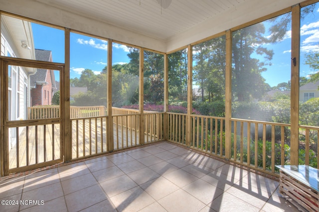 unfurnished sunroom with wood ceiling