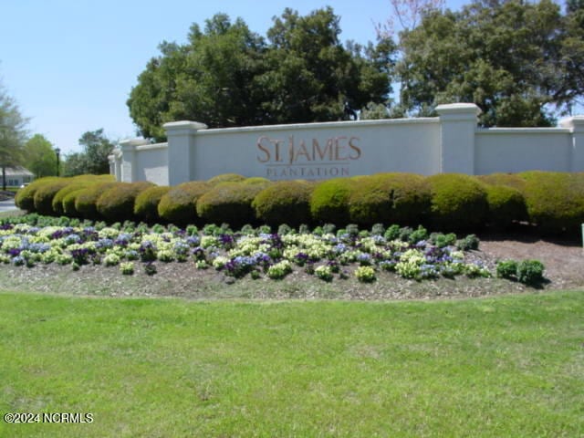 community / neighborhood sign with a yard